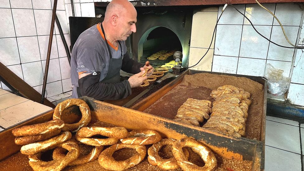Burhan Morkoc spends 17 hours a day shovelling bagel-like pastries in and out of a wood-burning oven at his bakery in Istanbul