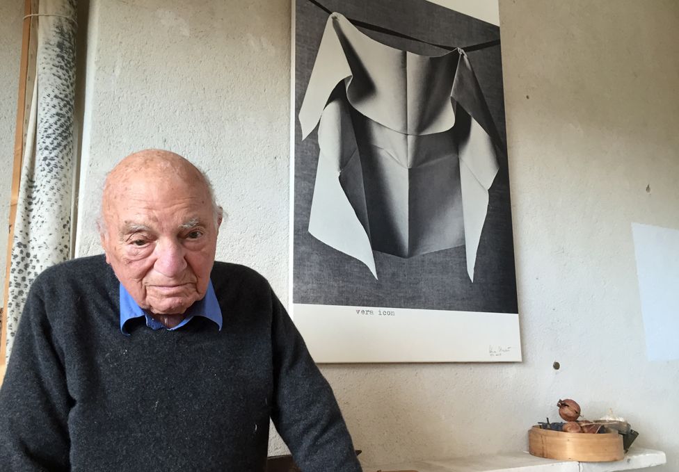 Stewart in front of one his photographs