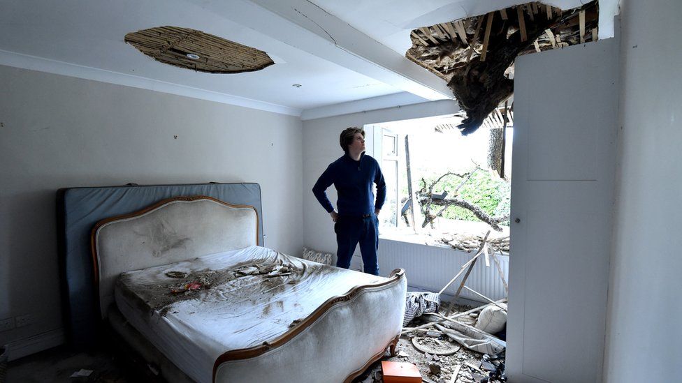 Sven Good in one of the bedrooms that has been damaged by the fallen tree