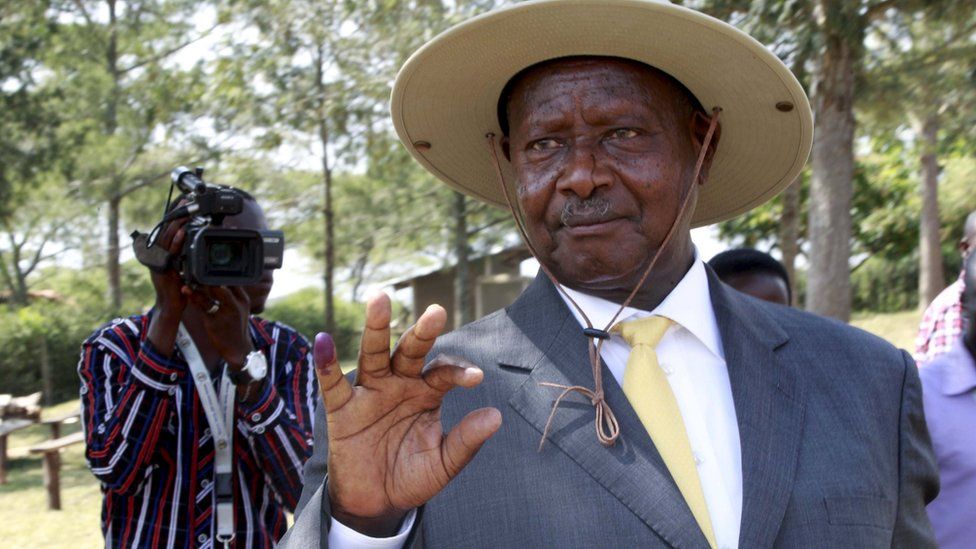 Ugandan President Yoweri Museveni shows his ink stained finger after voting in presidential elections