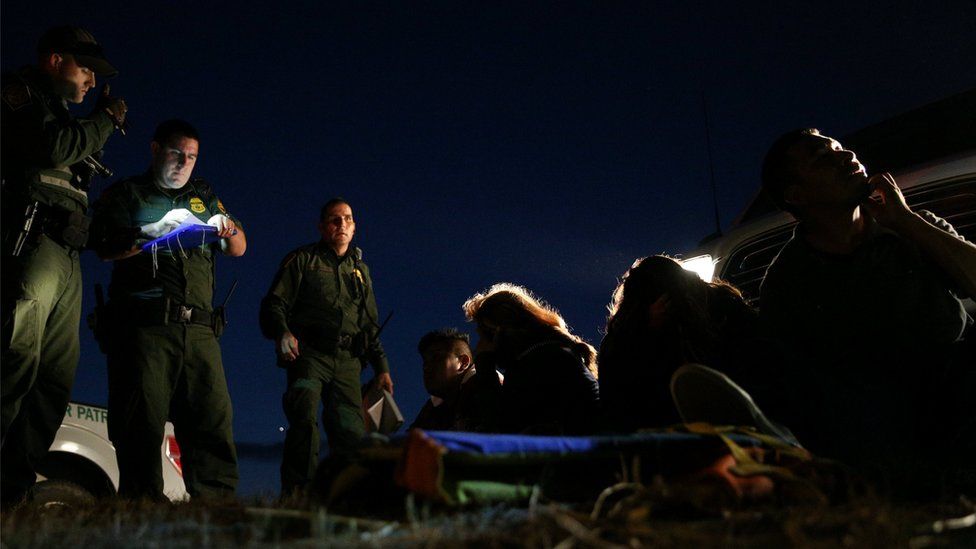 Border patrol agents apprehend immigrants who illegally crossed the Mexico-U.S. border near McAllen