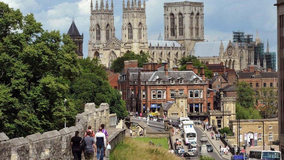 York Minster, people walking on city walls and traffic