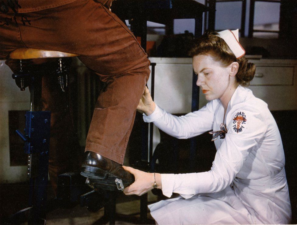 an Army Occupational Therapist adjusts a patient's foot