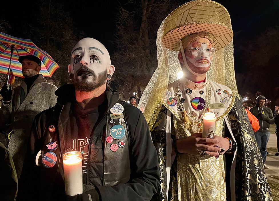 People hold candles during a vigil at Acacia Park for the victims of a mass shooting at Club Q, an LGBTQ nightclub, at Acacia Park in Colorado Springs, Colorado, US on 21 November 2022