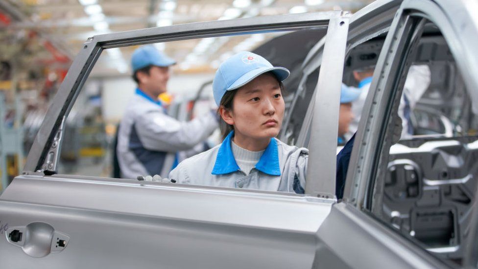 Worker on the assembly line of electric vehicles at a factory of Dayun Automobile in Yuncheng, Shanxi Province, China.