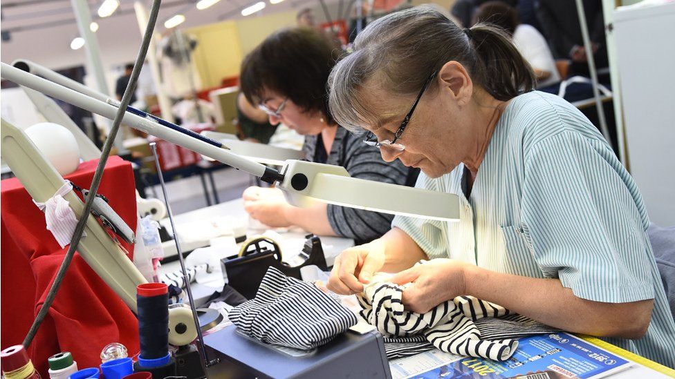 Workers sewing at French clothing firm Petit Bateau, in Troyes