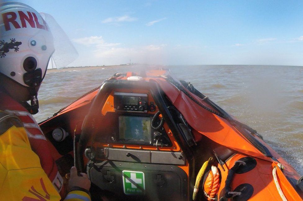 RNLI rescuer steering a lifeboat