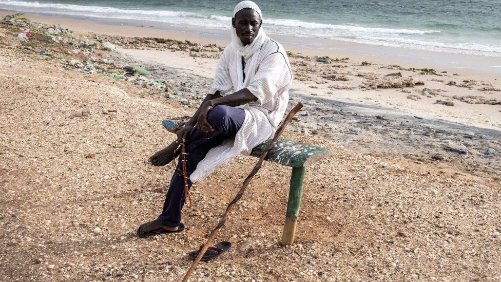 Man sitting on down on a beach in Senegal