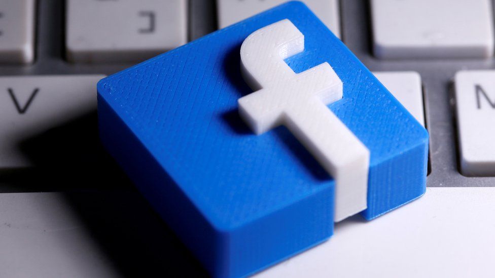A small tile of the Facebook logo is seen placed on a keyboard in this close-up show