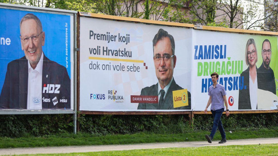 A man walks past election posters in Croatia