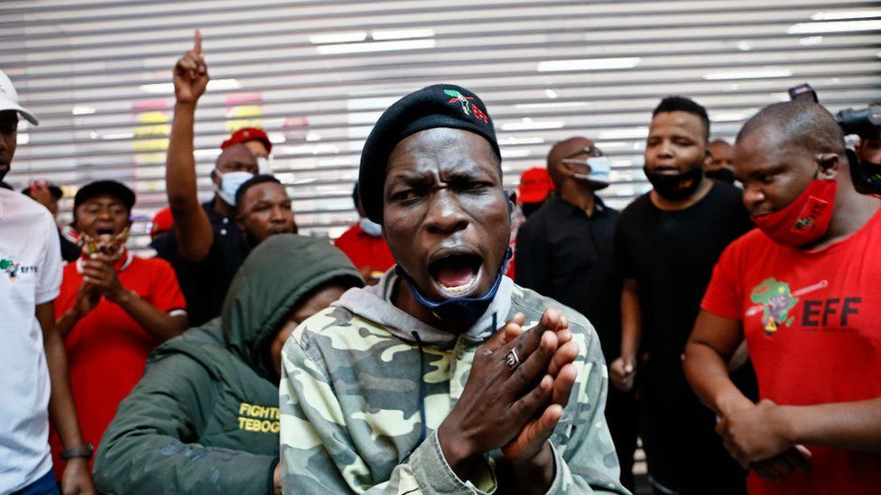 Economic Freedom Fighters (EFF) supporters chant during a picket outside a Clicks Store, at the Mall of the North in Polokwane, on September 7, 2020.