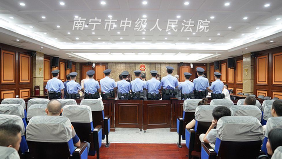 Police officers in court in Nanning
