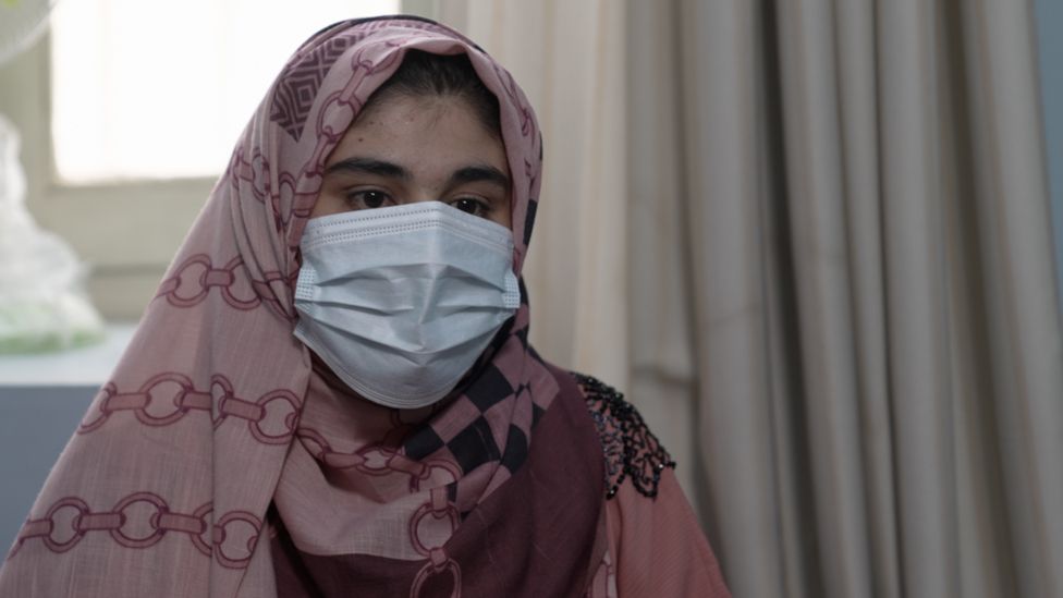 Negina Naseri wearing a mask in her home in Kandahar