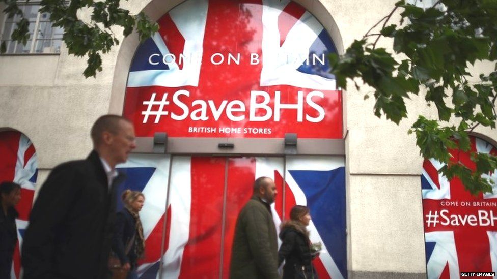 People walk past the headquarters of British Home Stores on 2 June 2016 in London