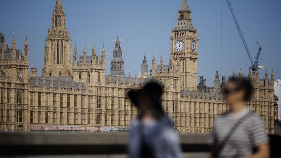 NEWS Individuals shuffle along the Southbank with The Palace of Westminster, dwelling to the Homes of Parliament, within the background in London, Britain, 04 September 2023.