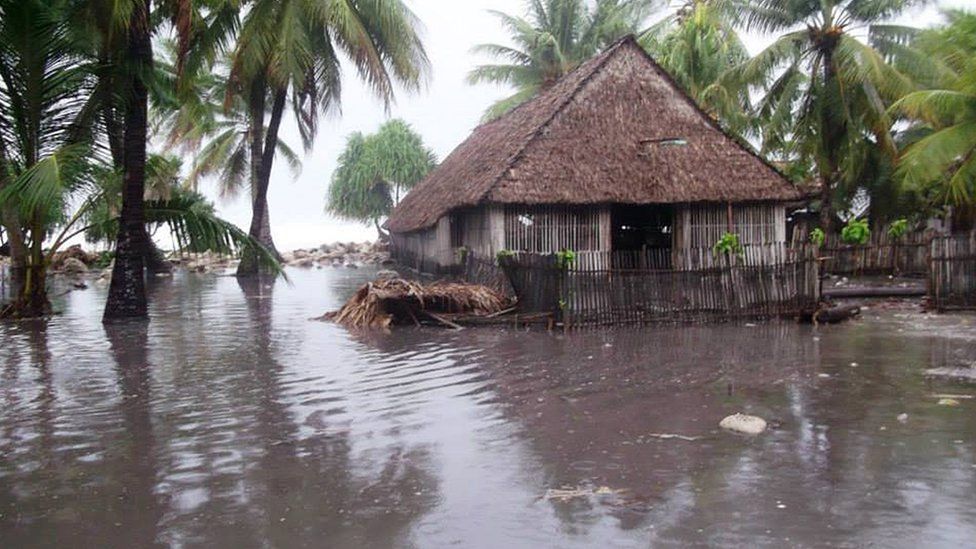In this handout image provided by Plan International Australia, flood waters surround a house 13 March 2015 on the island of Kiribati