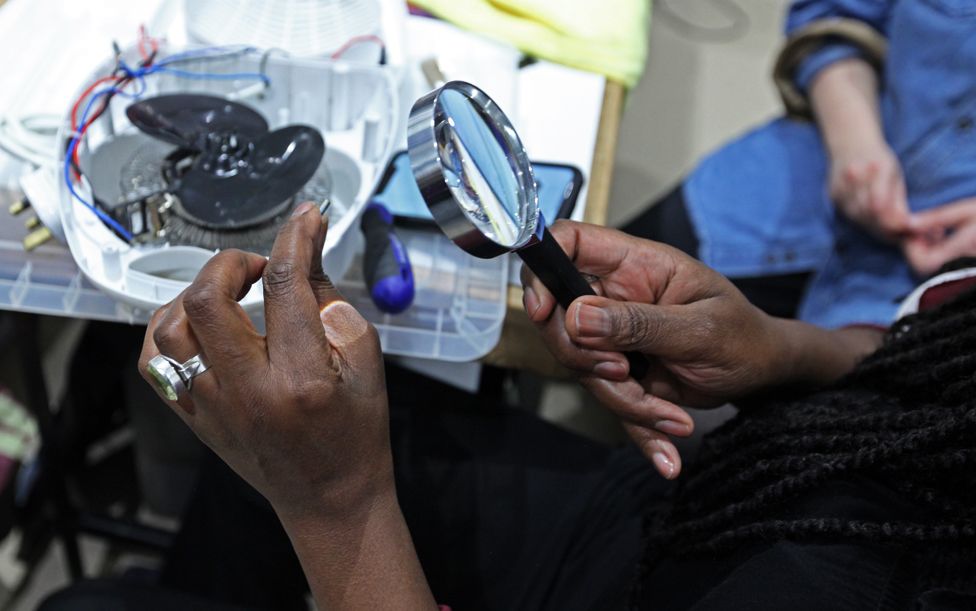 Volunteers repair electrical items at the Fixing Factory in Camden, London