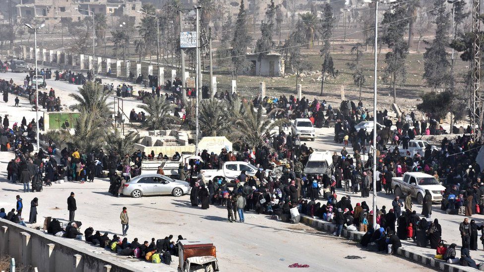Syrian civilians arrive at a checkpoint manned by pro-government forces after leaving eastern Aleppo on 10 December 2016