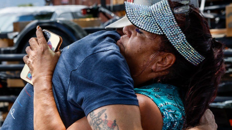 Melissah Shishido hugs a donor while gathering supplies at Costco for Lahaina residents