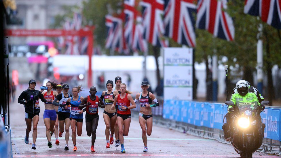 Britain's Lily Partridge and Stephanie Twell with Australia's Ellie Pashley and runners during the elite women's race of the London Marathon Pool