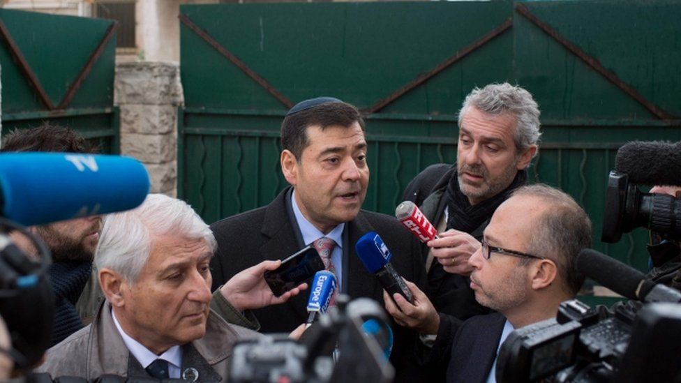 Marseille's Israelite Consistory president Zvi Ammar (centre) speaks to journalists in front of the La Source Jewish school in Marseille, southern France, on 11 January 2016