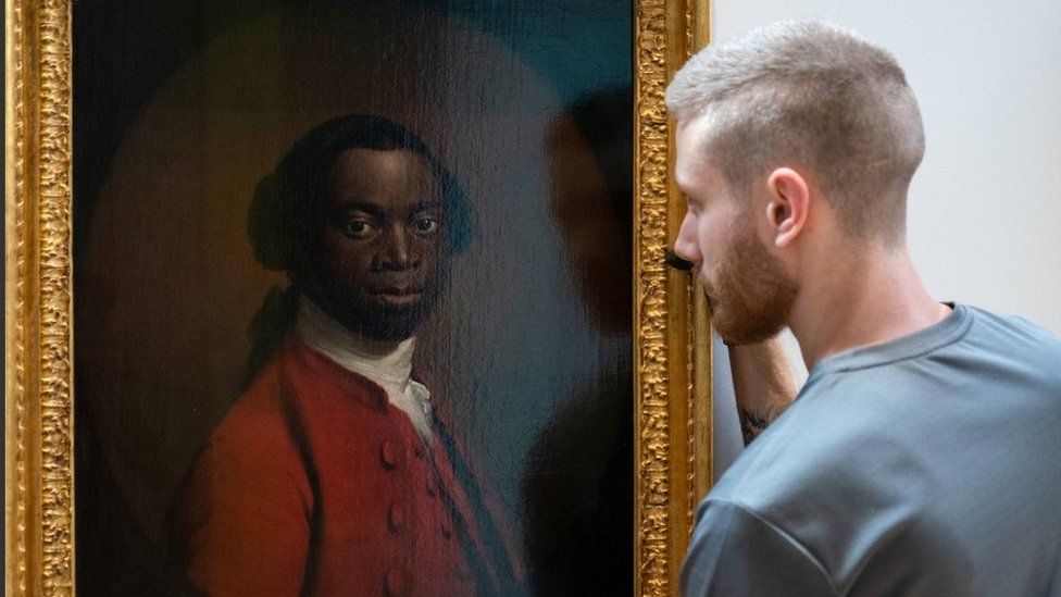Portrait of a Man in a Red Suit, c.1740-80, being lent by the Royal Albert Memorial Museum in Exeter, is hung during a photo call to mark the opening of Cambridge's Fitzwilliam Museum's new Black Atlantic: Power, People, Resistance exhibition.