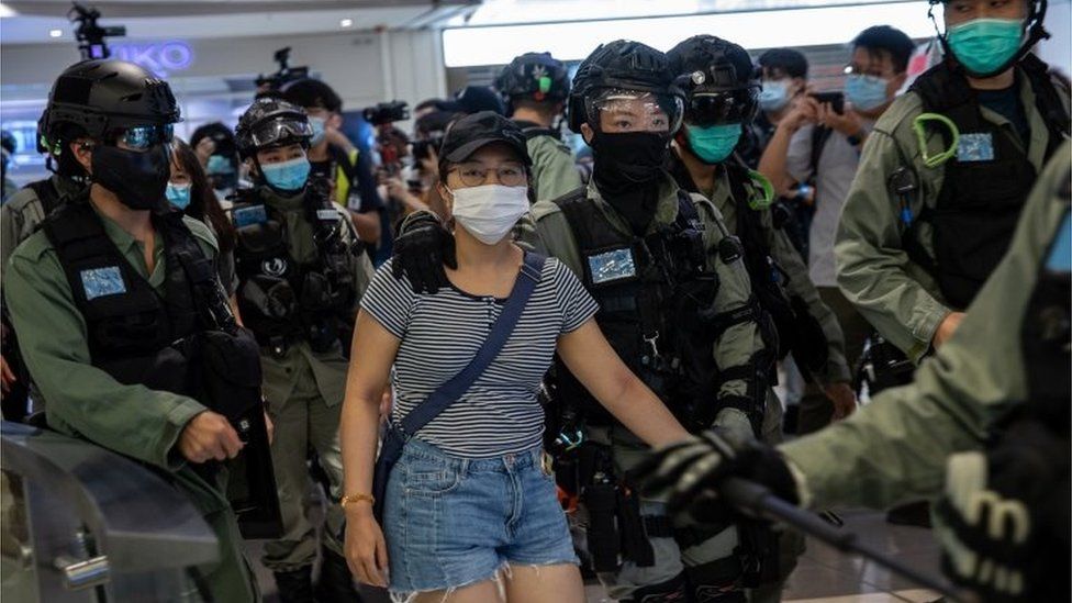 Police detain a woman, (C), during a protest in a shopping mall in Hong Kong, China, 06 July 2020. Several dozen protesters held up sheets of blank paper after the government issued a statement linking the â€˜Liberate Hong Kong, revolution of our timesâ€™ slogan, used during mall protests, to separatism.