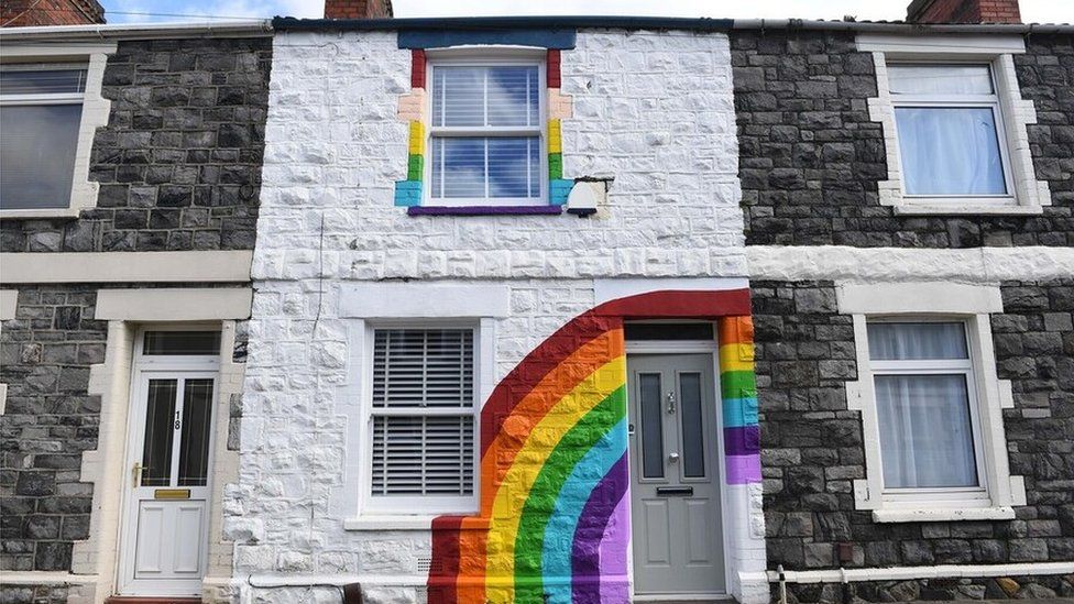 Rainbow painted on the front of a house in Splott, Cardiff