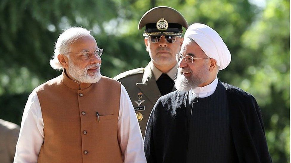 A handout picture provided by the office of Iranian President Hassan Rouhani on May 23, 2016 shows him (R) walking alongside Indian Prime Minister Narendra Modi during a welcome ceremony in Tehran.