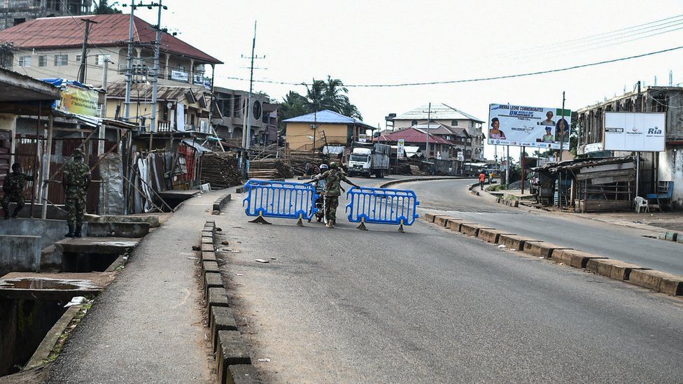 A man is questioned by Sierra leonean military police at a road block in Freetown on November 26, 2023.