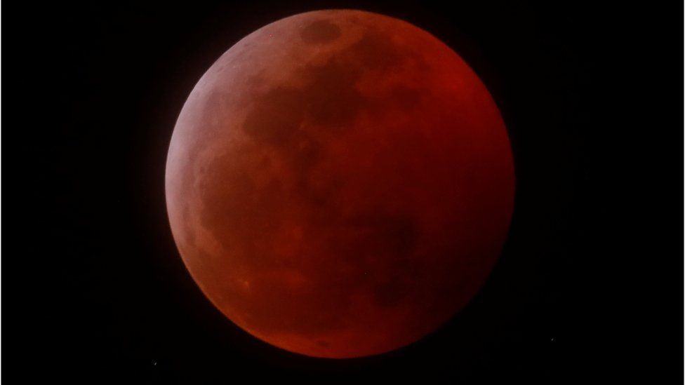 A total lunar eclipse that is called a "Super Blood Wolf Moon" is seen from Encinitas, California