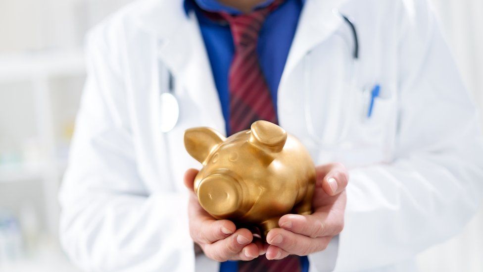 Doctor with a piggy bank
