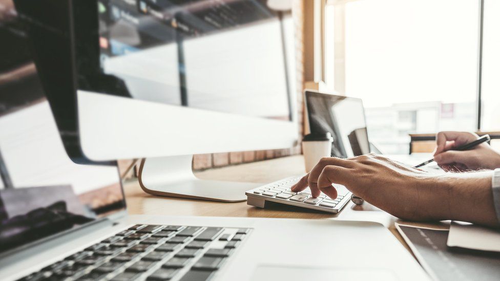 Person on keyboard in office