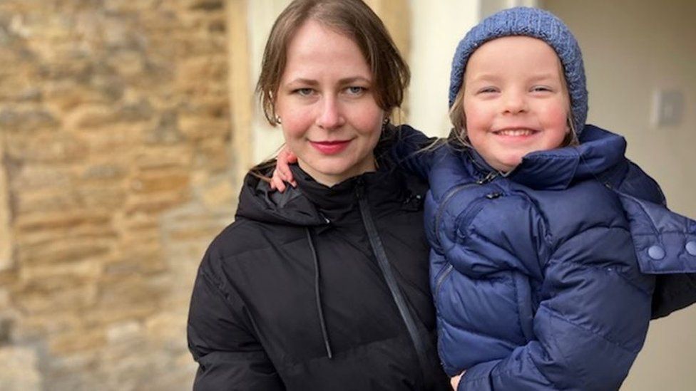 Natalia Nehriba standing holding her daughter Agnia