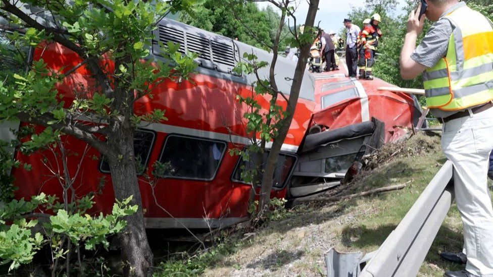 Rescue workers inspect the derailed train