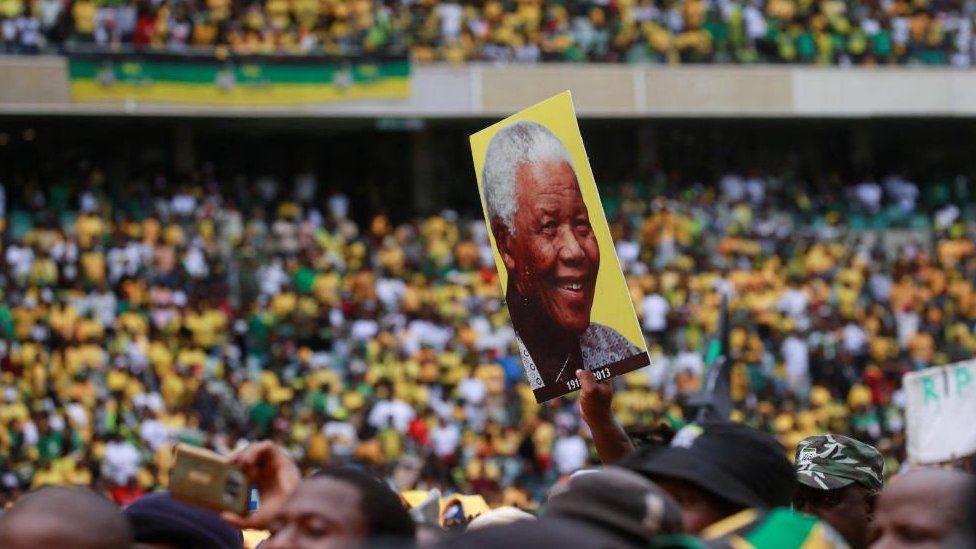 A supporter holds up a picture of former South African President Nelson Mandela at the African National Congress Election Manifesto launch in Durban, South Africa, February 24, 2024