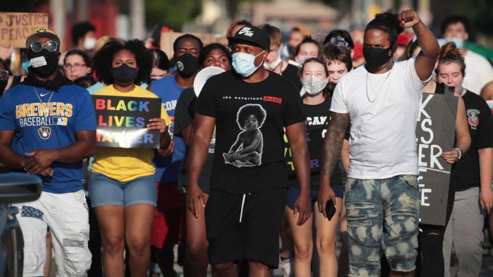 Protesters march during a demonstration held in the wake of the shooting of Jacob Blake by police officers, in Kenosha, Wisconsin, US, 27 August 2020