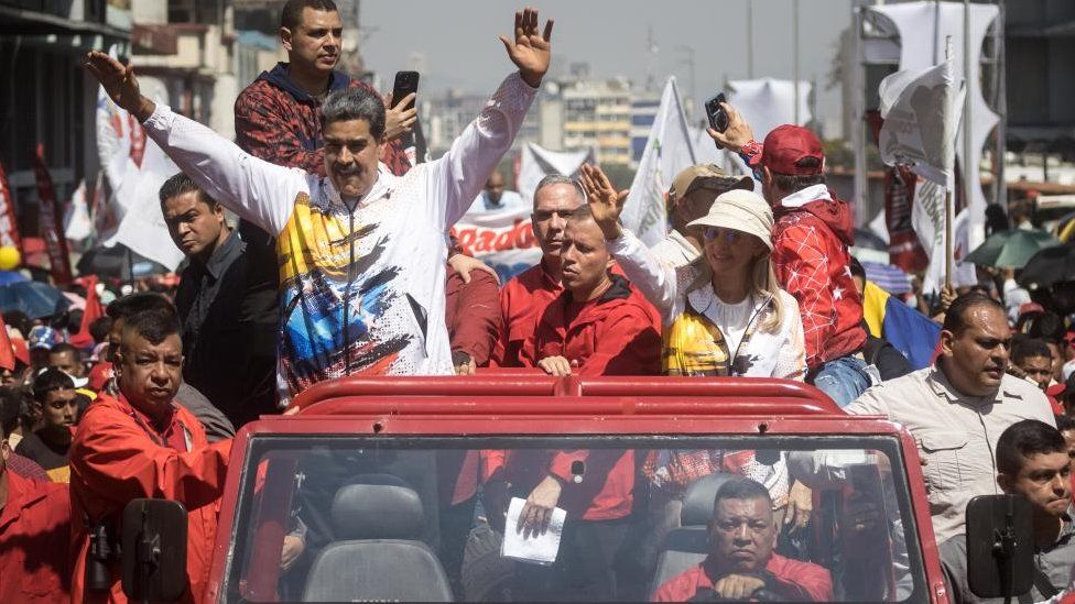 The president of Venezuela, Nicolas Maduro (C-L), greets his supporters during a demonstration in support of his candidacy for a third term, outside the headquarters of the National Electoral Council (CNE) in Caracas, Venezuela, 25 March 2024.
