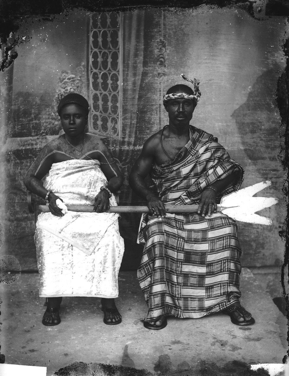 A couple dressed in traditional clothes in a photo studio
