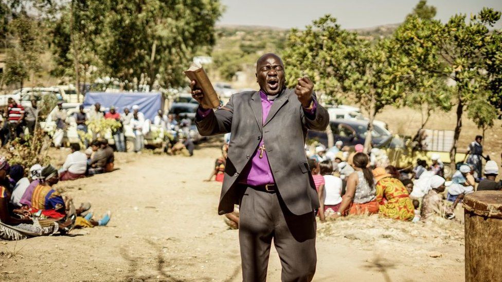 Bishop Guide Makore preaches during during the funeral ceremony of Ishmael Kumire, 42, shot during post-election violence on August 1 in Harare, at his homestead in Chinamhora village, Domboshava, outside Harare, on August 4, 2018.