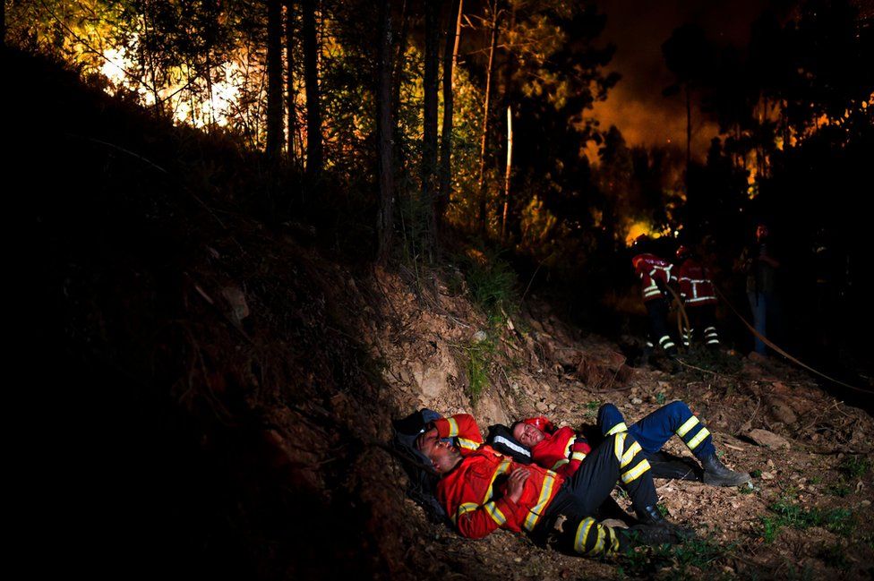 Fire fighters rest during a wildfire at Penela, Coimbra.