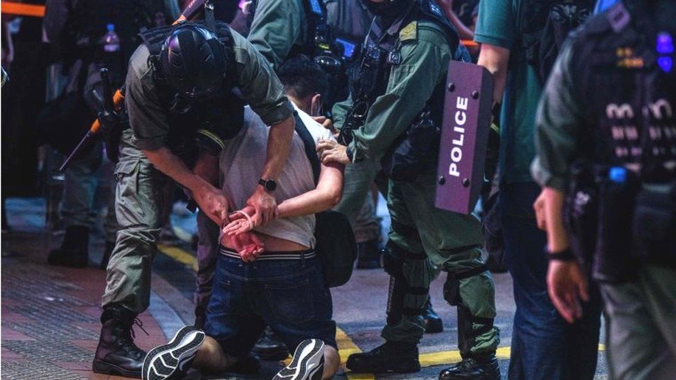Hong Kong police detain a man in Causeway Bay, 12 June