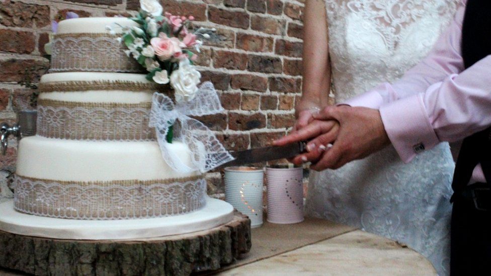 Couple cutting wedding cake