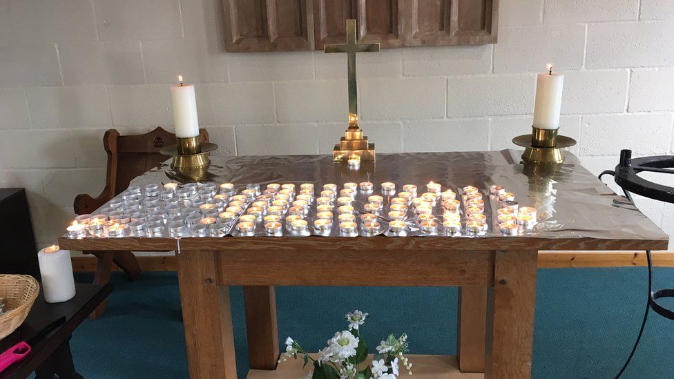 Picture of the candle-lit vigil at St Peter's Church in Rhoose