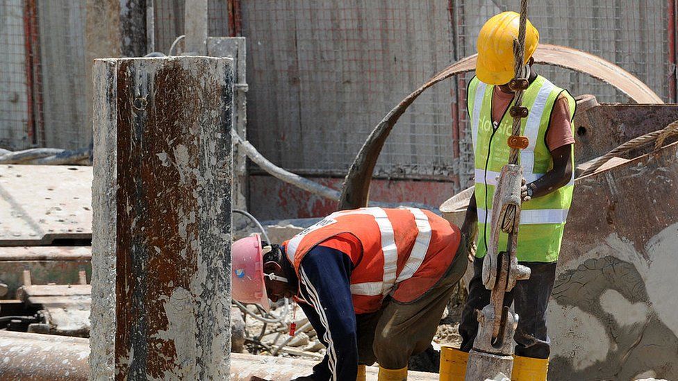 Two foreign workers are seen at a construction site in Singapore on April 29, 2008.
