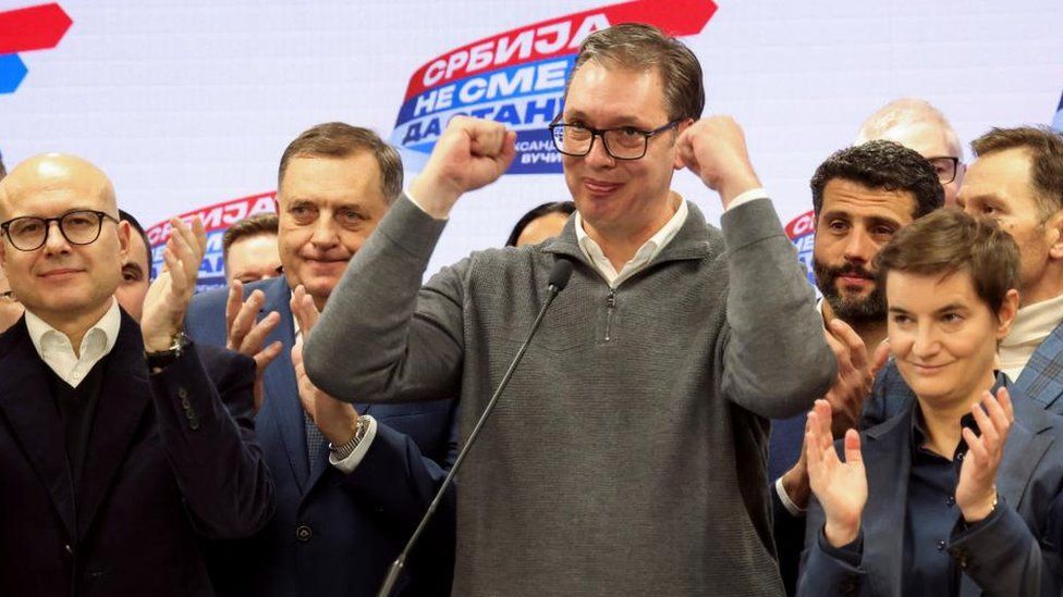 Serbian President Aleksandar Vucic gestures on stage at Serbian Progressive Party (SNS) headquarters