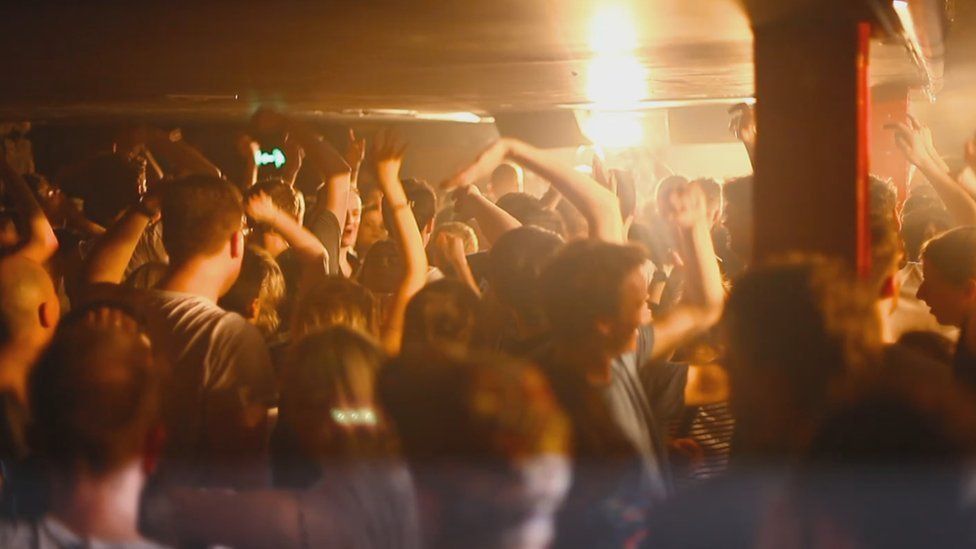 People dancing in a packed nightclub