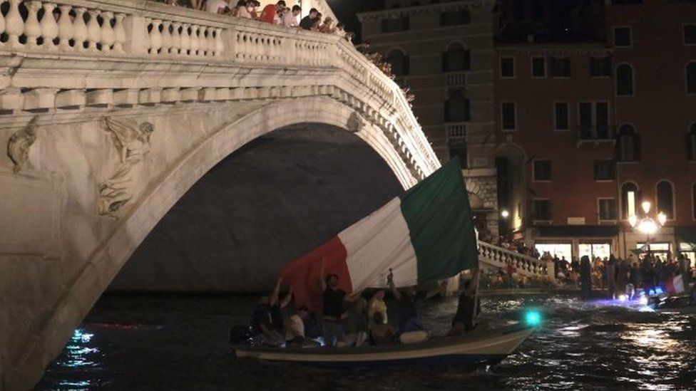 Italy fans celebrate inside a boat after winning the Euro 2020