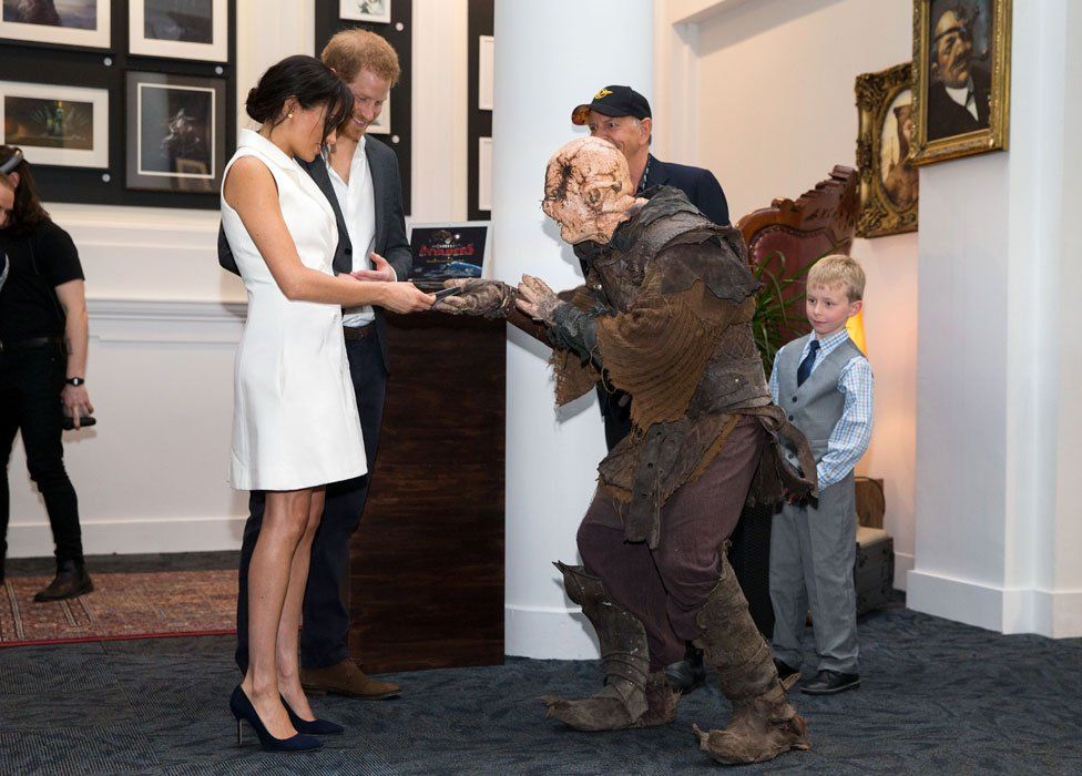 Meghan being given a gift by an orc soldier