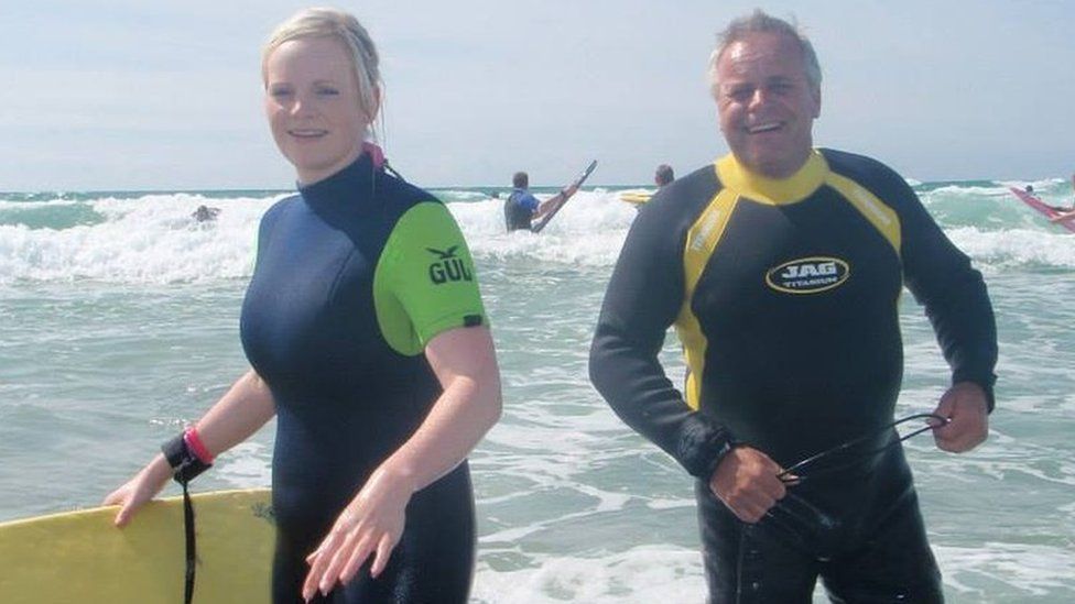 Joanne Young and John Hadley surfing while on holiday at Perranporth